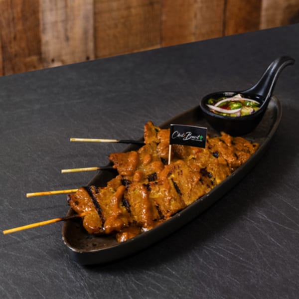 Chili Basil Thai Cuisine's grilled chicken satay skewers with peanut sauce and a side of dipping sauce.